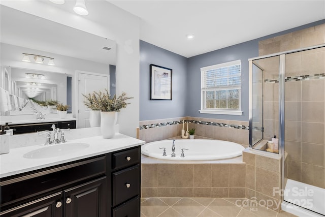 bathroom featuring vanity, tile patterned flooring, and separate shower and tub