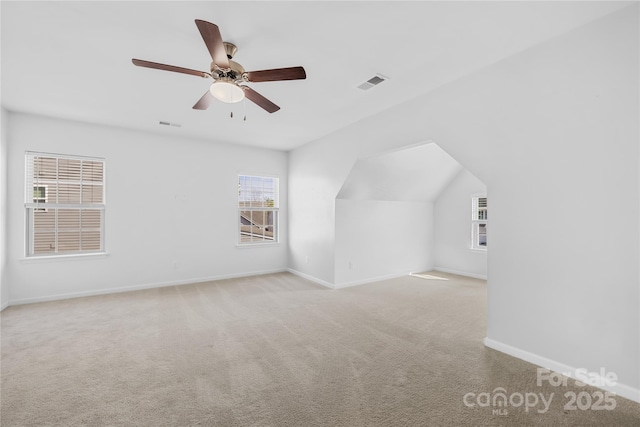 additional living space featuring light carpet and ceiling fan