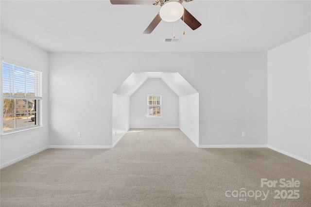 bonus room featuring light colored carpet and ceiling fan