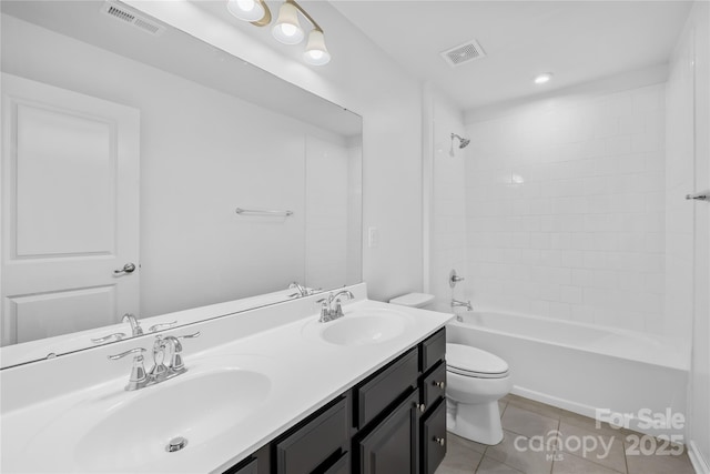 full bathroom featuring tile patterned flooring, vanity, tiled shower / bath combo, and toilet