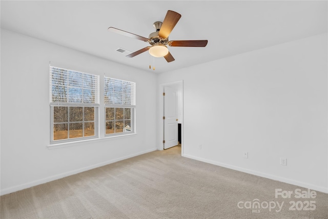 carpeted empty room featuring ceiling fan