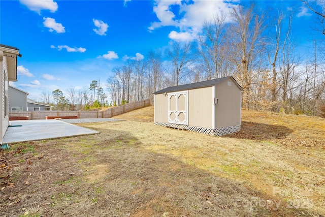 view of yard with a storage shed and a patio