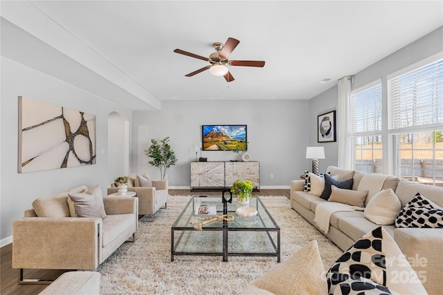 living room featuring ceiling fan and light hardwood / wood-style flooring