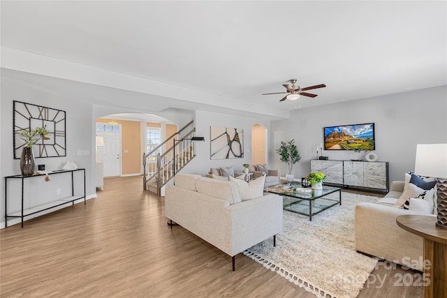 living room featuring ceiling fan and hardwood / wood-style floors