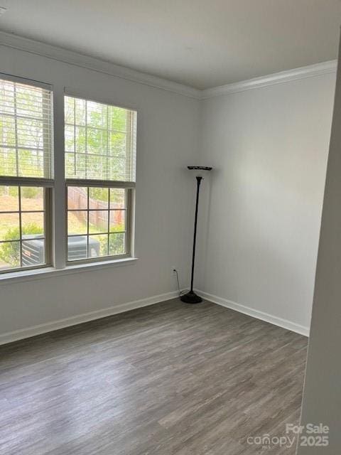 7405 Bosson St SW, Concord, NC 28025 - empty room featuring baseboards, ornamental molding, and dark wood finished floors