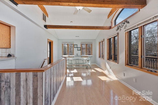 corridor featuring vaulted ceiling with beams and light wood-type flooring