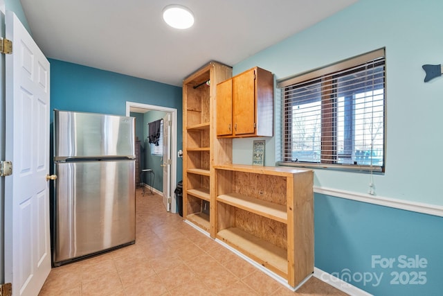 kitchen with stainless steel refrigerator and light tile patterned flooring