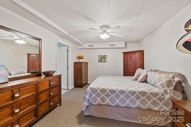 bedroom featuring light carpet, a paneled ceiling, and ceiling fan