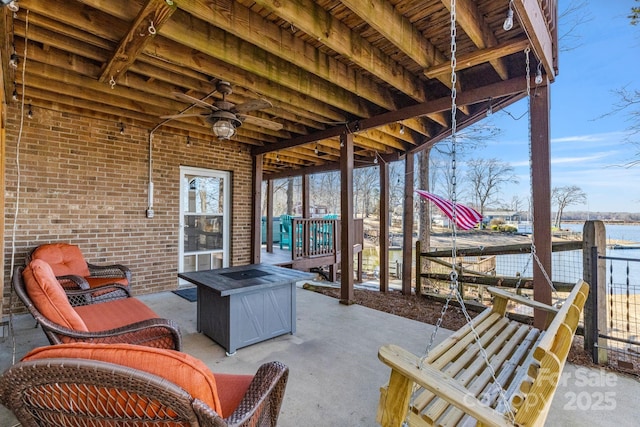 view of patio / terrace featuring a water view and ceiling fan