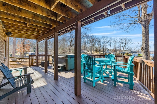 wooden terrace with a hot tub