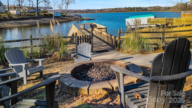 view of dock featuring a water view and an outdoor fire pit