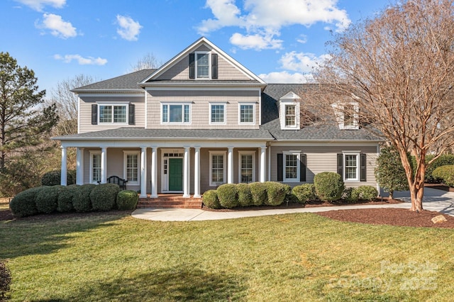 view of front of house with a front yard and covered porch