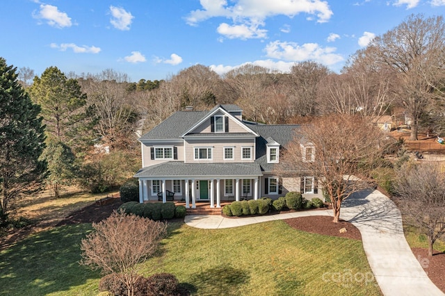 view of front facade with a front lawn and covered porch