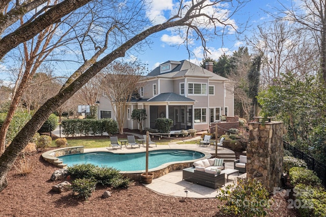 back of house with a patio and a sunroom