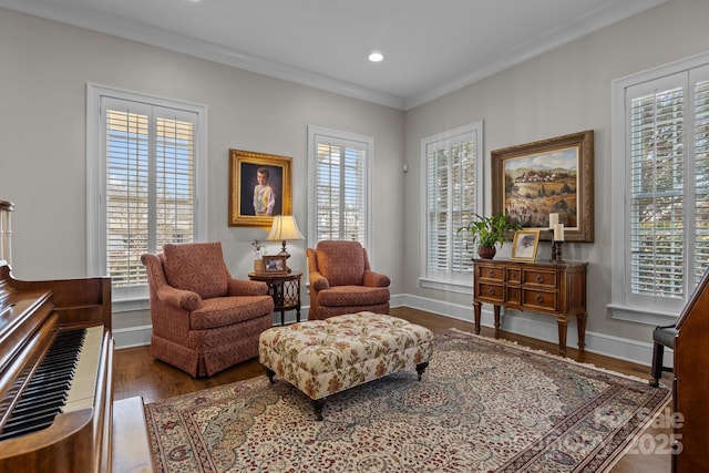 living area with ornamental molding, plenty of natural light, and hardwood / wood-style floors