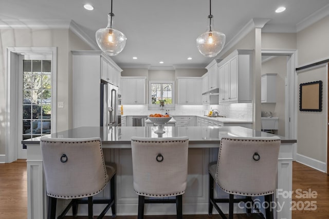 kitchen featuring white cabinetry, a center island, and decorative light fixtures