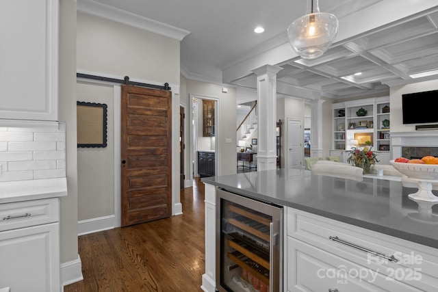 kitchen with wine cooler, pendant lighting, and white cabinets