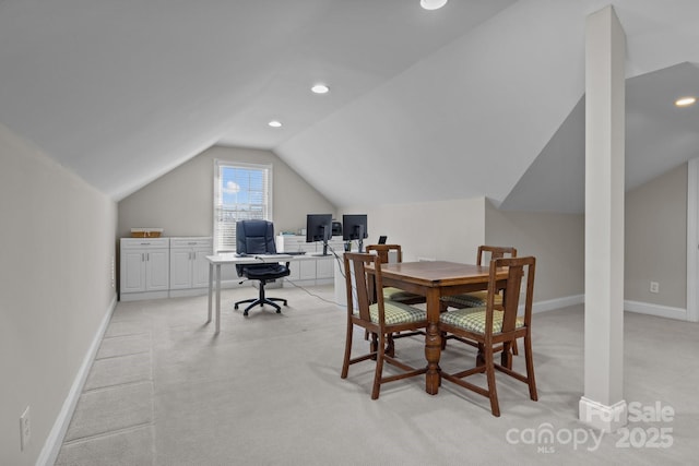 carpeted home office featuring vaulted ceiling