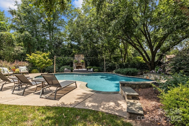 110 Lynbrook Dr, Davidson, NC 28036 - swimming pool with a patio area and view of wooded area