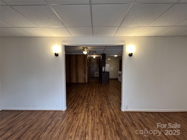 corridor featuring a drop ceiling and dark hardwood / wood-style floors