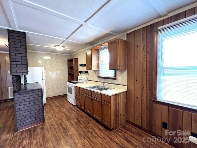 kitchen with sink, dark wood-type flooring, decorative columns, coffered ceiling, and white electric stove