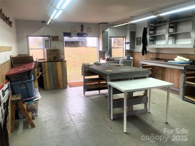 interior space featuring wooden walls and a workshop area