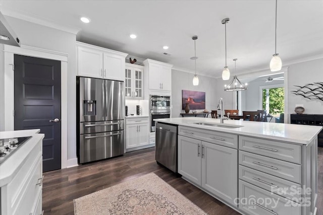 kitchen with sink, a center island with sink, white cabinets, and appliances with stainless steel finishes