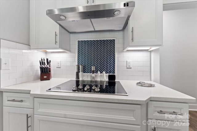 kitchen featuring white cabinetry, black electric stovetop, dark wood-type flooring, and backsplash