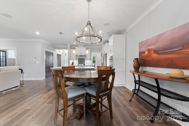 dining room featuring hardwood / wood-style floors and ornamental molding