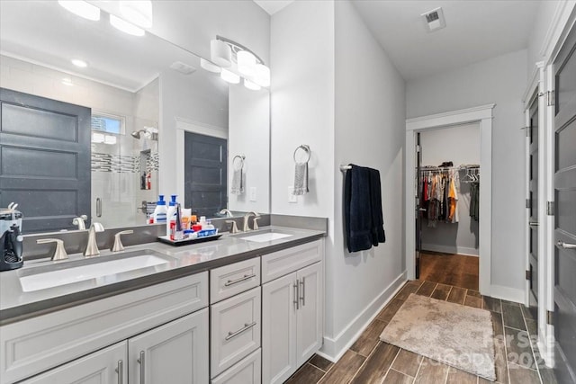 bathroom featuring vanity and a shower with door