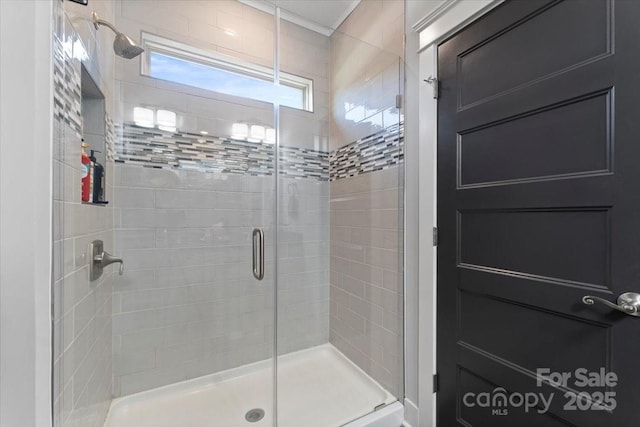 bathroom featuring a shower with shower door