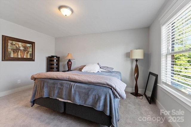 bedroom featuring light colored carpet