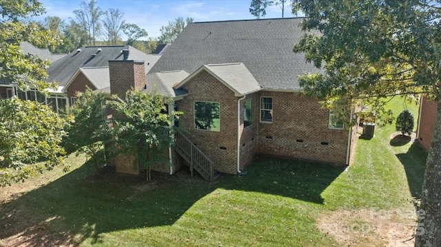 rear view of property with a yard