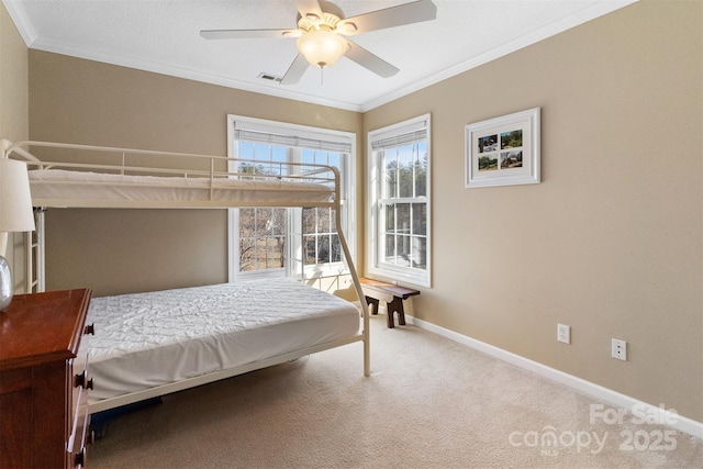 bedroom with ceiling fan, visible vents, baseboards, ornamental molding, and carpet