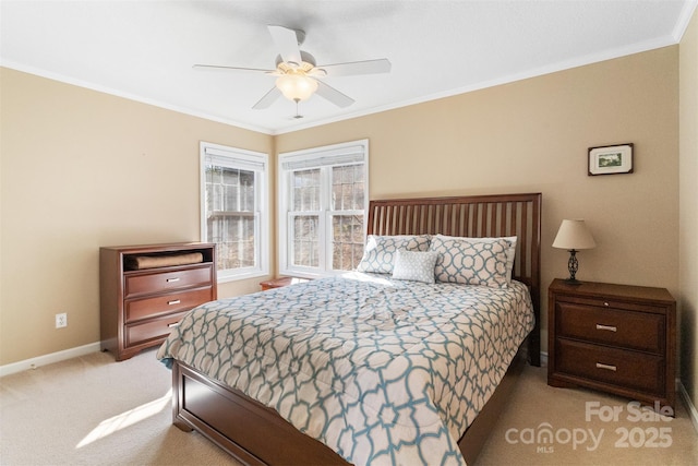 bedroom with carpet floors, crown molding, baseboards, and a ceiling fan