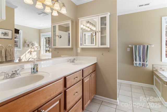 bathroom featuring ornamental molding, visible vents, and a sink