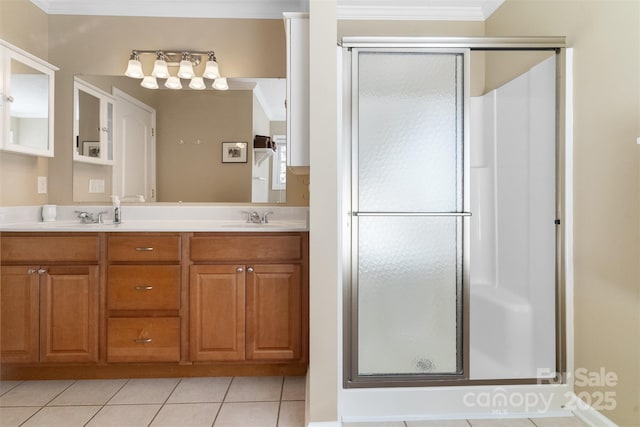 bathroom with crown molding, double vanity, a sink, a shower stall, and tile patterned flooring