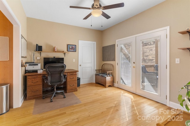 office featuring light wood finished floors, baseboards, a ceiling fan, and french doors