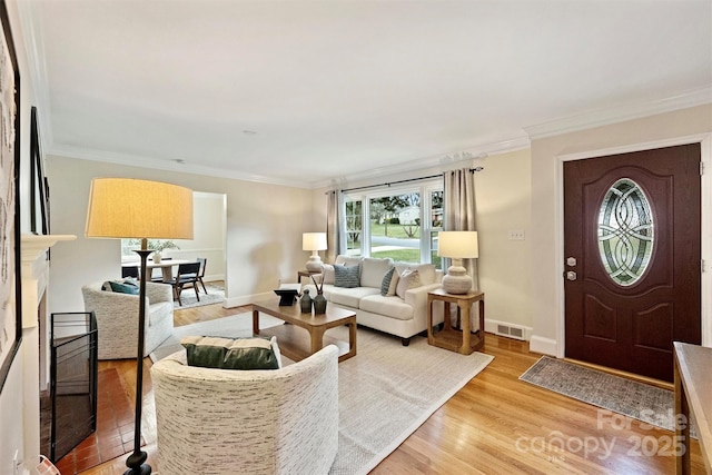 living room with ornamental molding and hardwood / wood-style floors