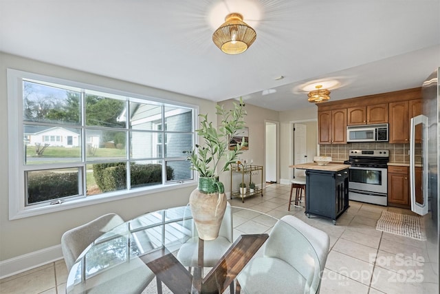 dining space featuring light tile patterned floors and plenty of natural light