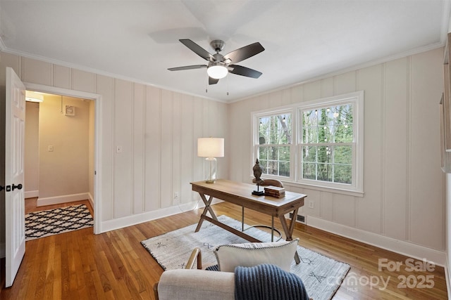 home office featuring hardwood / wood-style floors, crown molding, and ceiling fan