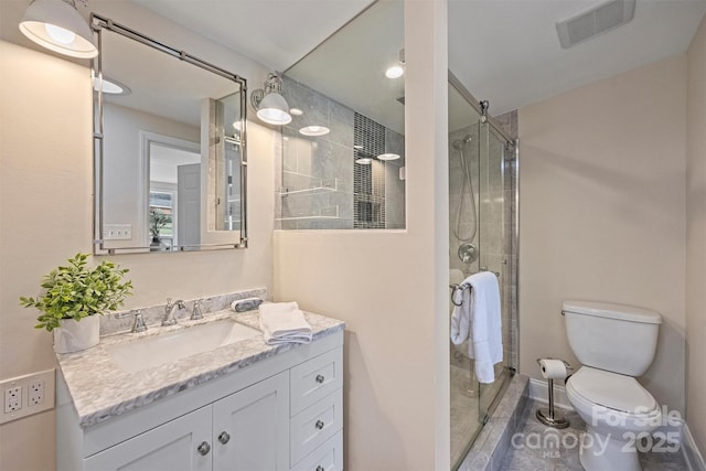 bathroom featuring toilet, vanity, and walk in shower