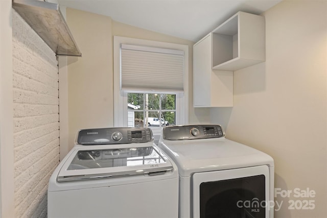 clothes washing area featuring washer and clothes dryer