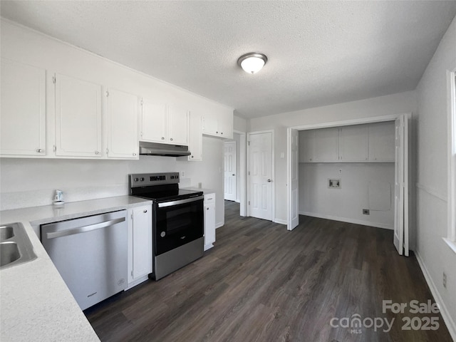 kitchen featuring white cabinetry, appliances with stainless steel finishes, dark wood-type flooring, and a textured ceiling