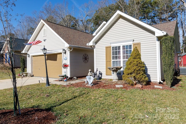 view of front of property with a garage and a front lawn