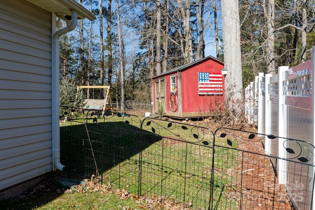 view of yard featuring a playground and a storage shed