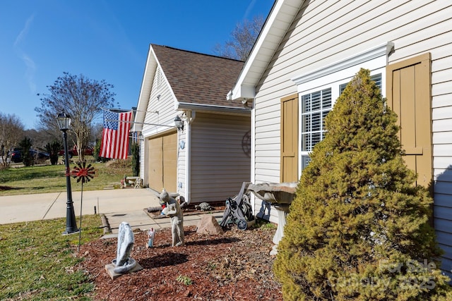 view of side of home featuring a garage