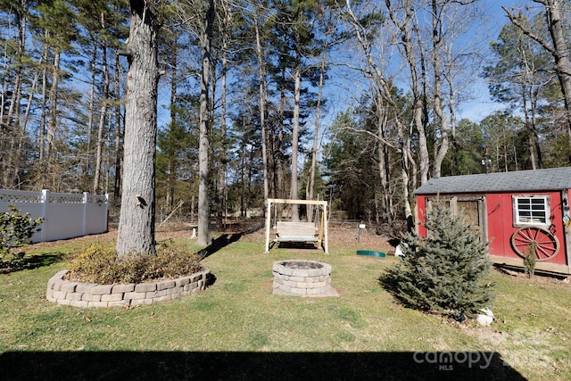 view of yard featuring an outdoor fire pit and a shed