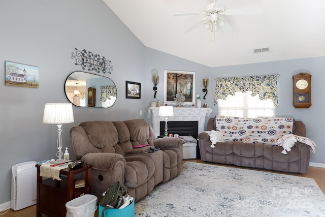 living room featuring ceiling fan, vaulted ceiling, and hardwood / wood-style floors