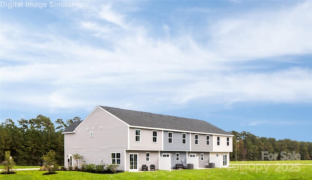 rear view of property with a yard and central AC unit